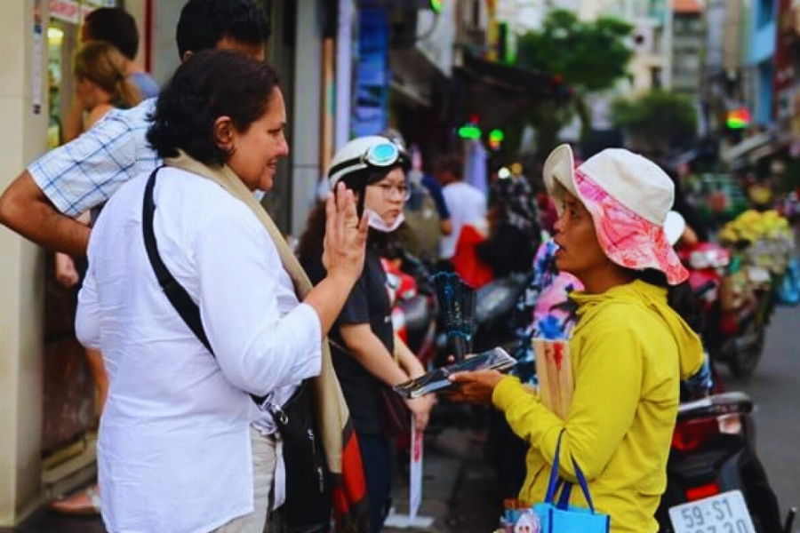 Tourists interact with locals at Vietnam market – cultural experience Auasia Travel